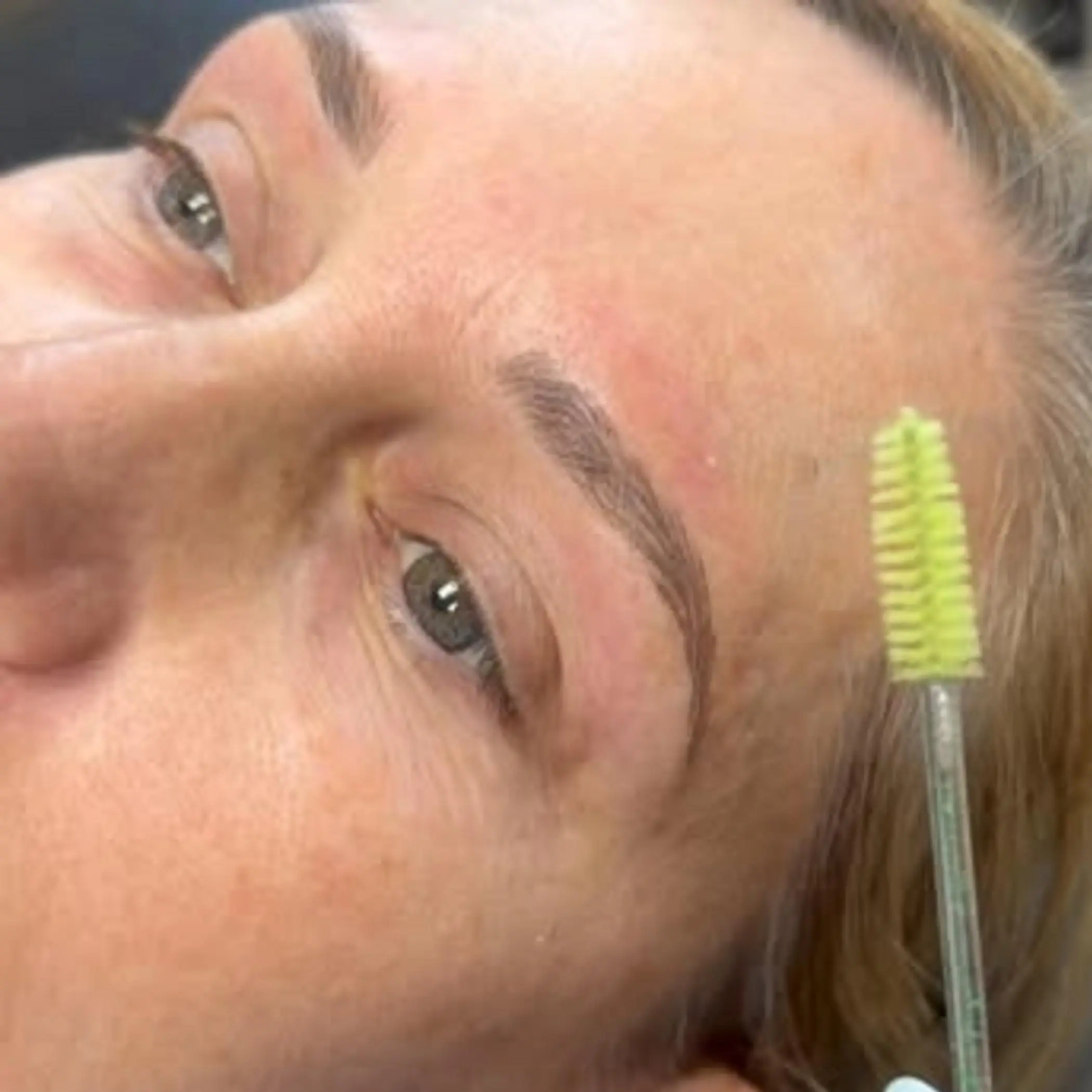 artist performing nano brows treatment
