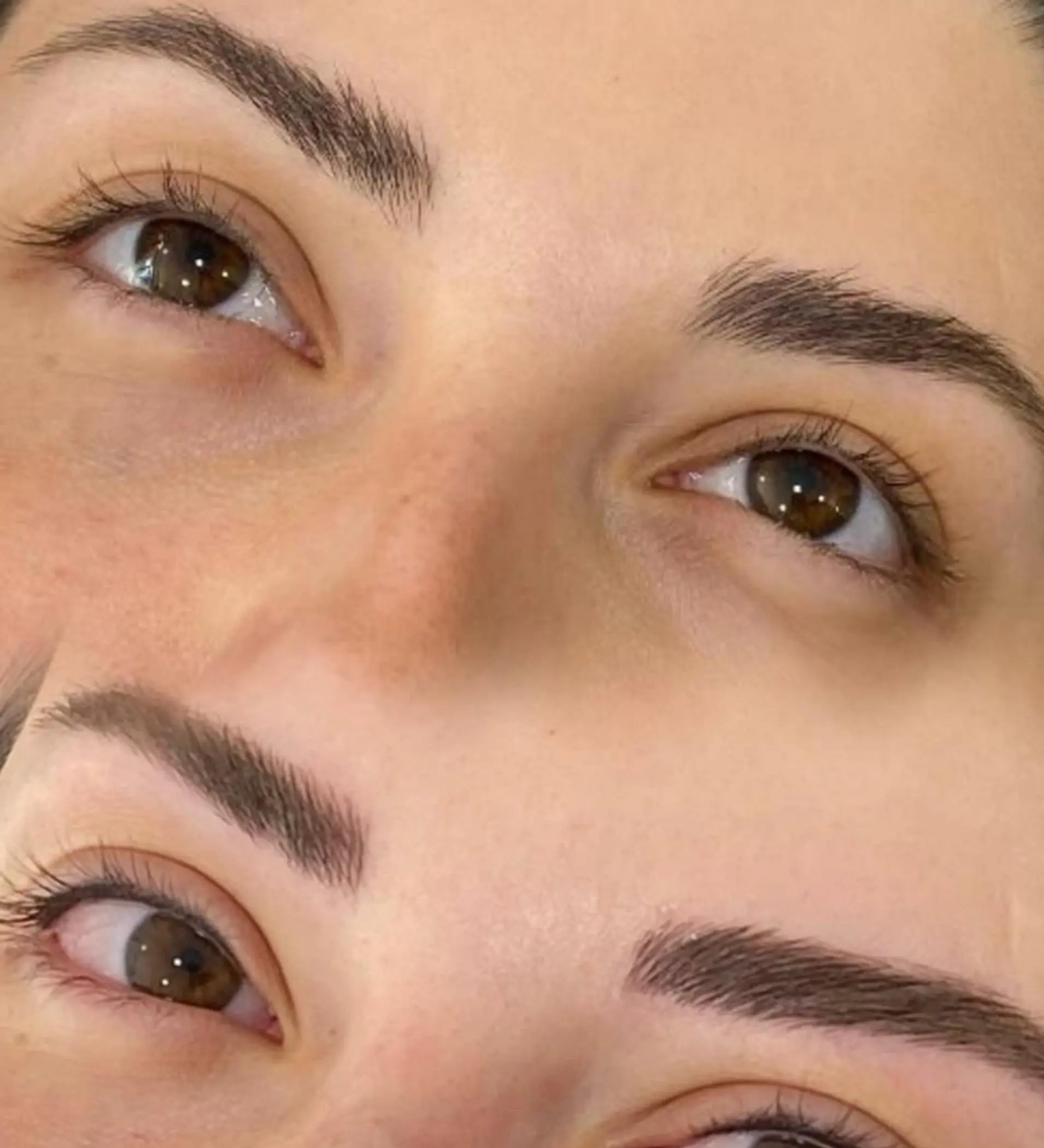 artist shaping eyebrows with precision tools