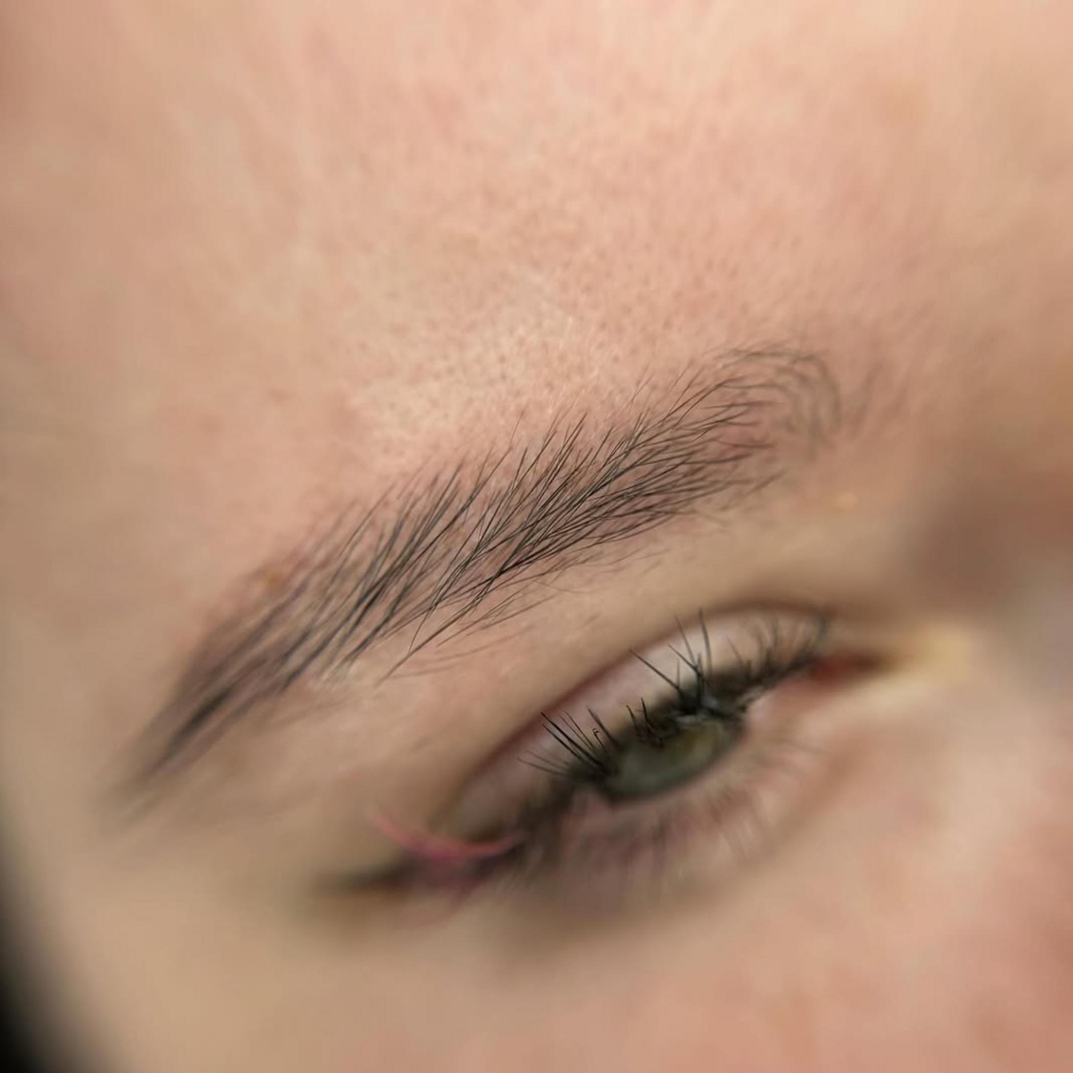close up healed eyebrow tattoo detail
