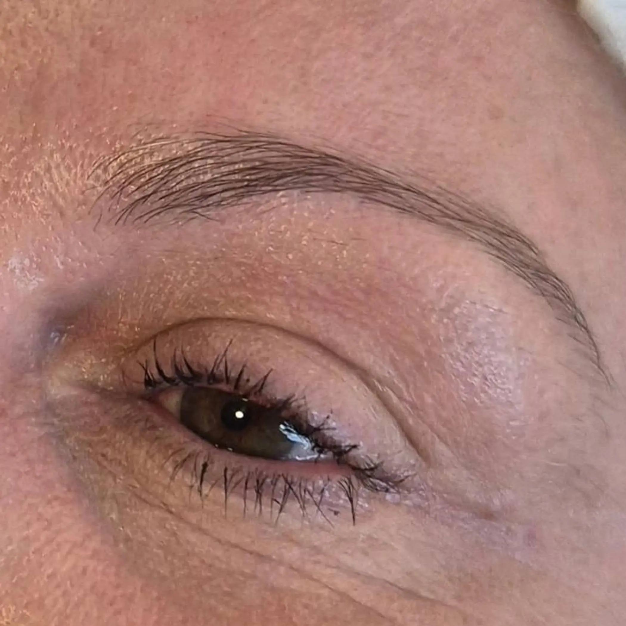technician performing powder brow procedure