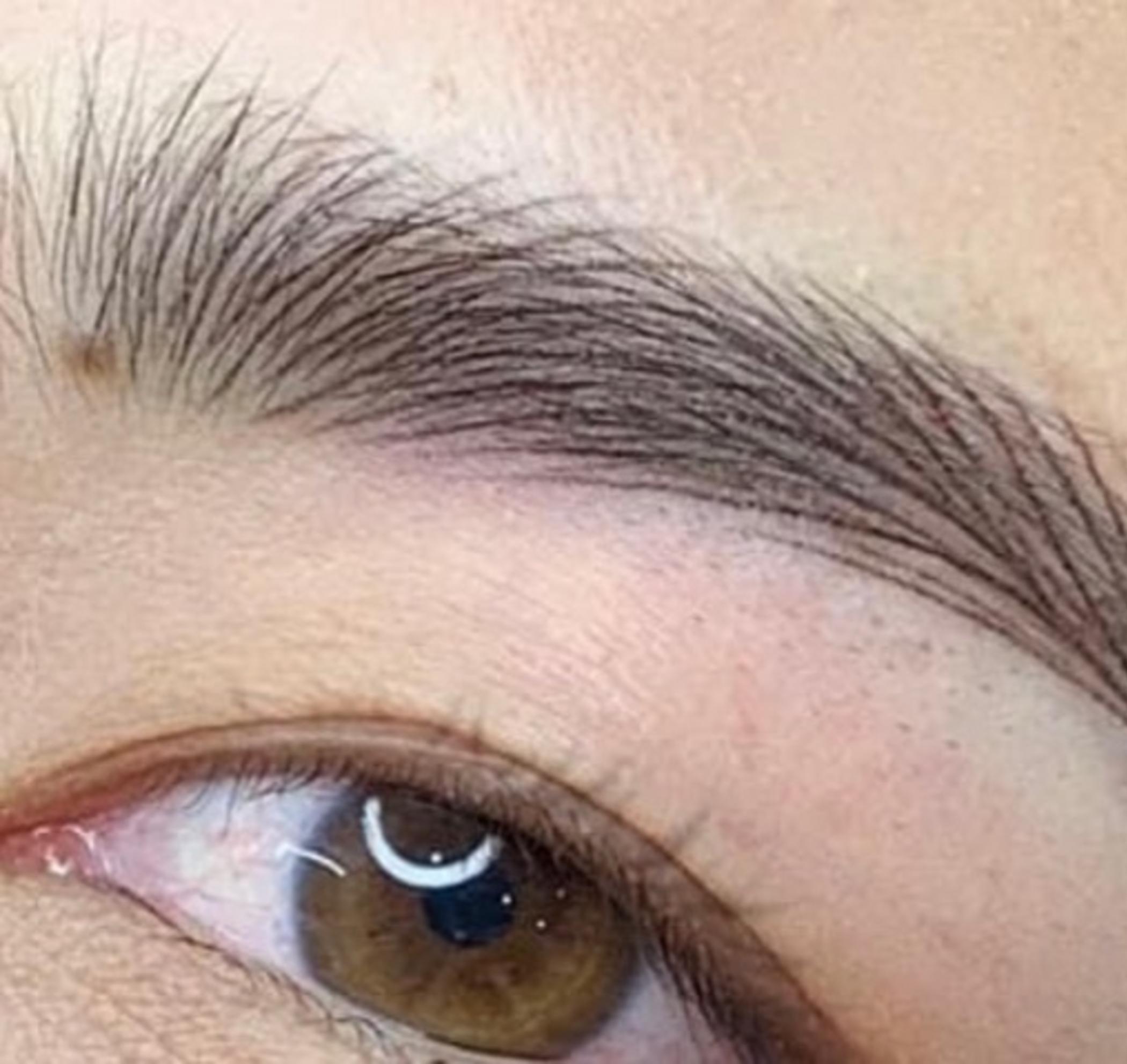 technician performing powder brow shading
